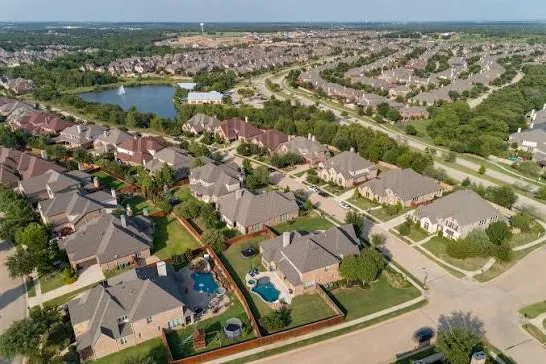 Aerial view of homes and a pond in Argyle, Texas