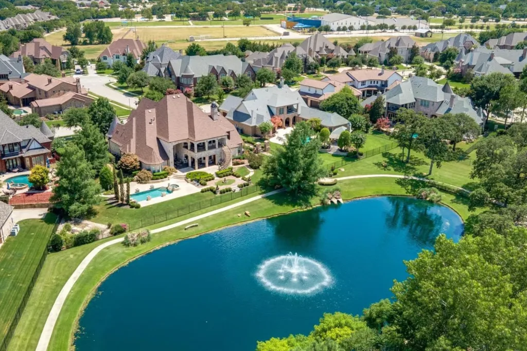 Aerial view of homes around a fountain pond in Colleyville, Texas
