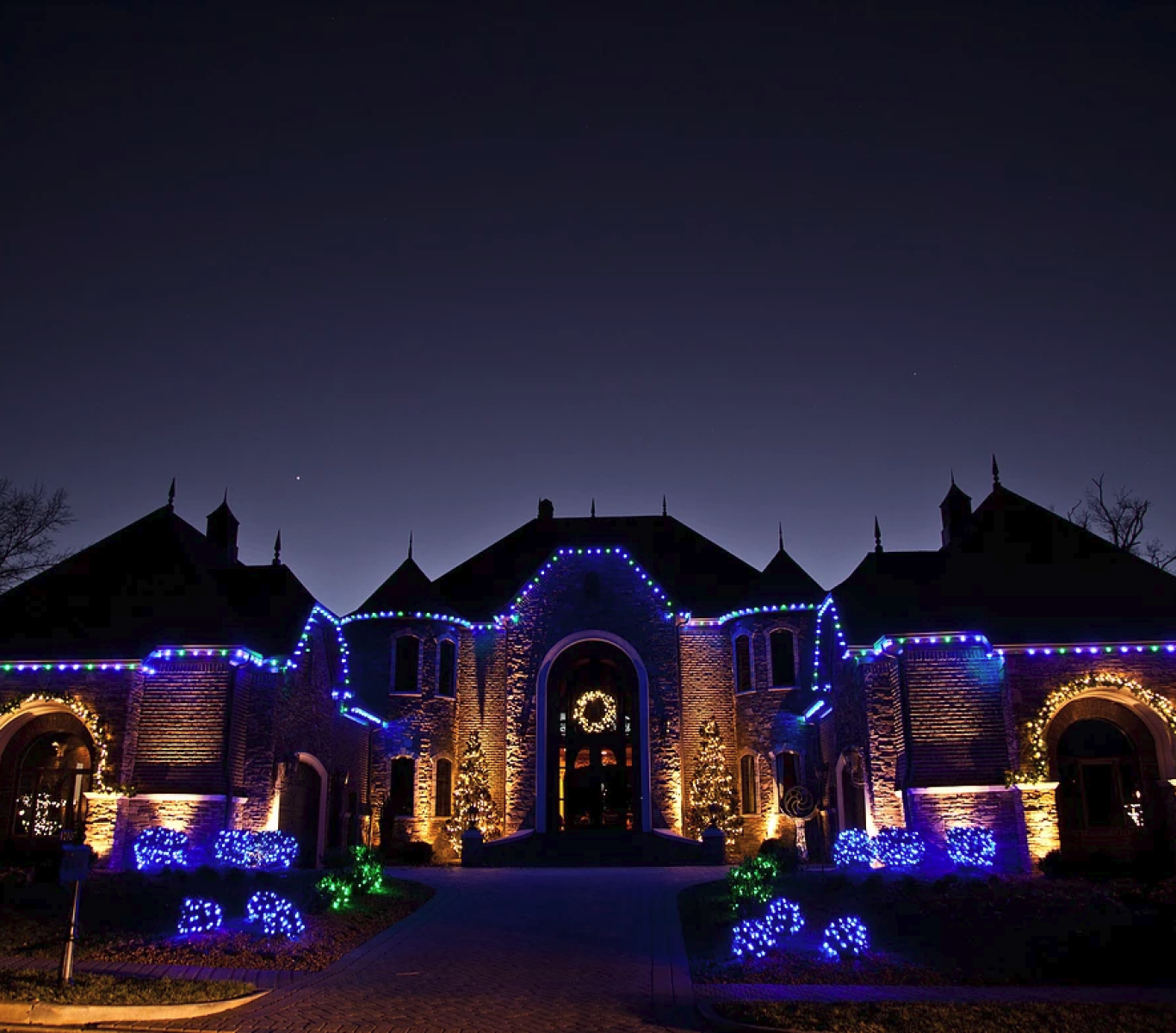 Team carefully removing lights from a residential roof after the season